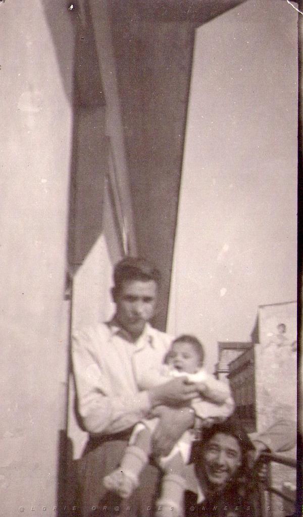 mon papa qui tient mon frère marcel dans ses bras et à coté mon oncle didier serra au 1 rue déligny à st antoine  oran.jpg